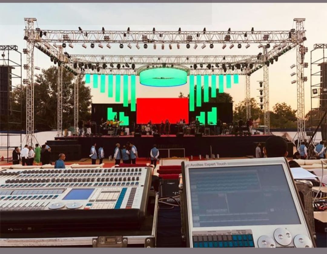 Lighting console facing a concert stage