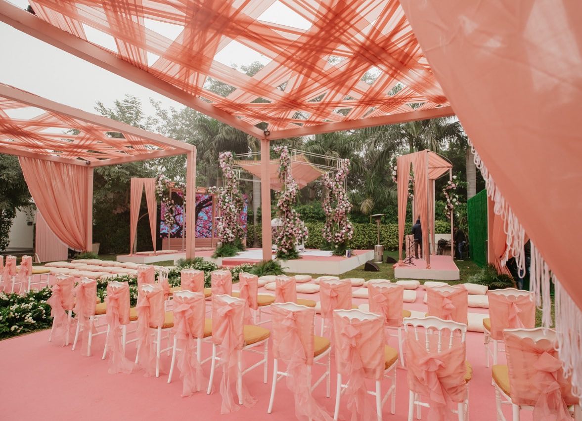 Layered pink draped pergola ceremony
